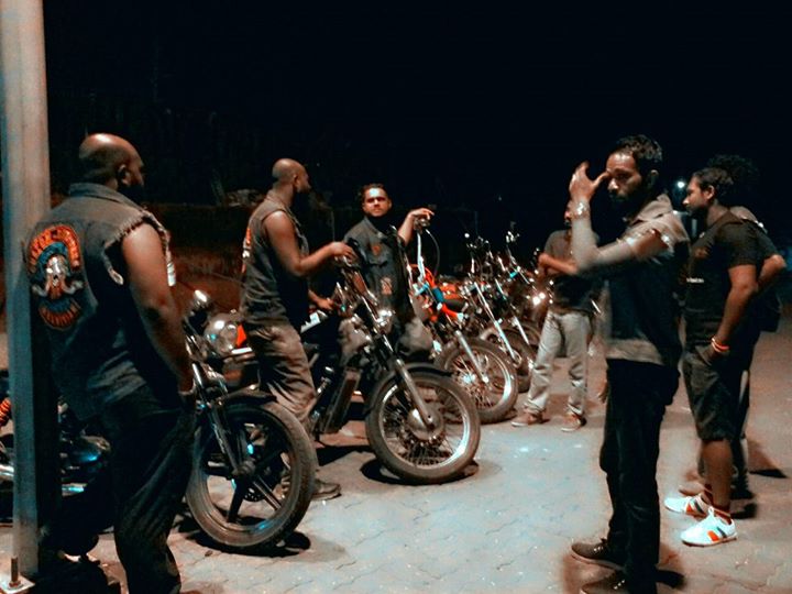 MCC members with custom motorcycles at night